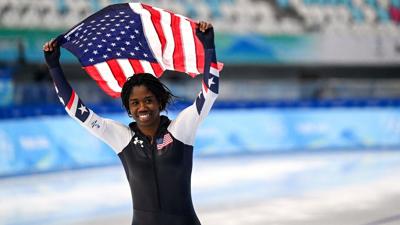 Erin Jackson smiling, holding American flag