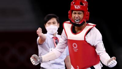 CHIBA, JAPAN - JULY 26: Paige McPherson (R) of Team United States celebrates after defeating Nur Tatar of Team Turkey during the Women's -67kg Taekwondo Quarterfinal contest on day three of the Tokyo 2020 Olympic Games at Makuhari Messe Hall on July 26,...