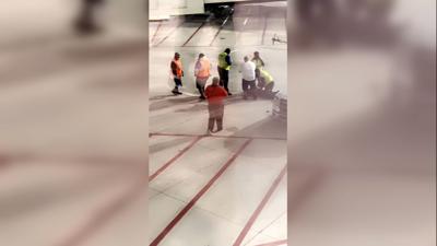 A Southwest Airlines passenger opened an emergency exit and climbed onto a plane’s wing while the aircraft was at the gate
